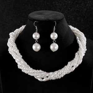 Elegant multi-layer woven pearl necklace and drop earrings set on black jewelry display
