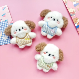 Three cute plush puppy dolls in yellow blue and green overalls on a pink background