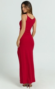 Detail of elegant red backless maxi dress with side slit and slim fit silhouette
