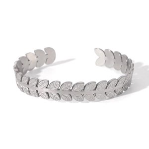 Macro detail of silver leaf texture on adjustable stainless steel open bangle