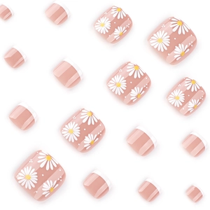 Daisy press-on toe nails with white floral pattern and French tip design in nude pink