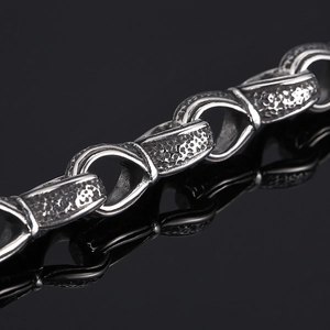 Macro view of vintage silver titanium steel chain showing polished and hammered textures