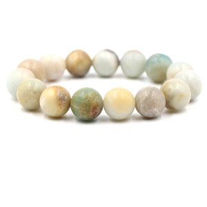 Elastic natural stone bead bracelet with mixed green and beige round gemstones on white background