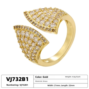 Detail view of gold brass ring with cubic zirconia paving and 4.8g weight specification