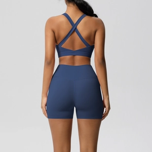 Detail of high-waist yoga shorts and criss-cross back sports bra in navy blue fabric