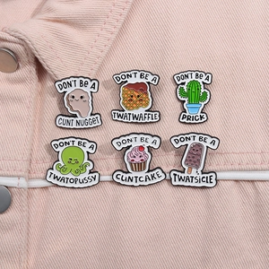 Macro view of six cartoon enamel pins featuring cute food and cactus on pink denim