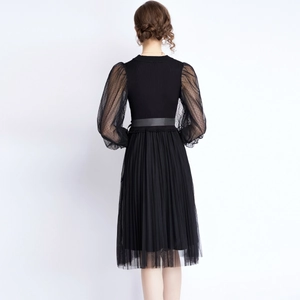 Elegant black knit dress with polka dot sheer mesh puff sleeves and pleated skirt