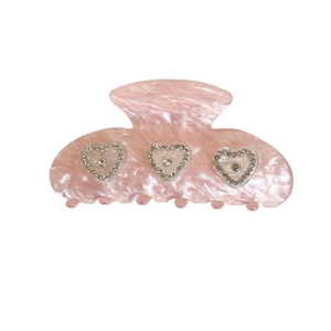 Pink acetate hair claw clip with sparkling rhinestone hearts on a clean white background