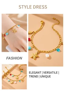 Detail of gold chain bracelet with sea star and turtle charms and colorful gemstones