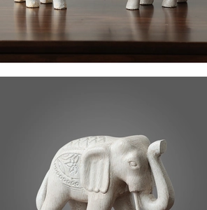 Sculpture en relief détaillée sur une statue d'éléphant blanche aux motifs floraux