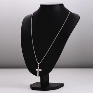 Double-layered silver stainless steel necklace with textured cross pendant on black bust
