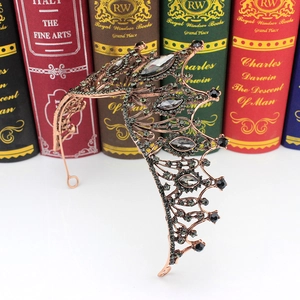 Detail shot of Gothic Baroque crown with black rhinestones and bronze wing design