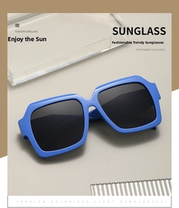 Detail of bright blue square thick frame sunglasses with black polarized lenses