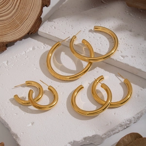 Three sizes of 18K gold plated C-shaped stainless steel hoop earrings on stone background