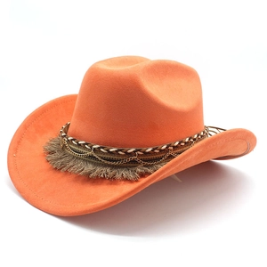 Detail of orange suede cowboy hat featuring woven cord, gold chain, and fringe band
