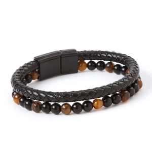 Detail of multi-layer tiger eye stone beads and black braided leather bracelet with magnetic clasp