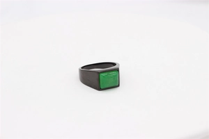 Detailed view of rectangle green gemstone set on a black stainless steel ring band
