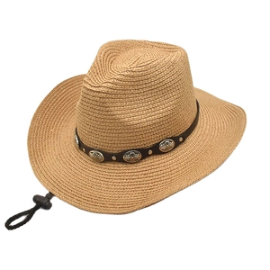 Close-up of woven straw cowboy hat featuring leather band with vintage silver studs
