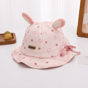 Detail of pink baby bucket hat with rabbit ears and cute floral cartoon patterns