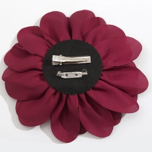 Detailed back view of burgundy fabric flower brooch with silver metal duckbill clip and pin