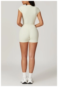Rear view of cream-colored slim fit yoga set featuring high-waist shorts and short sleeves