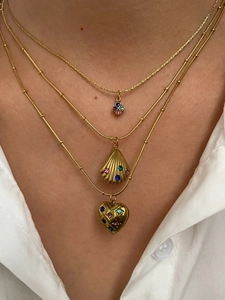 Detailed view of triple-layered gold necklaces with clover, shell and heart charms
