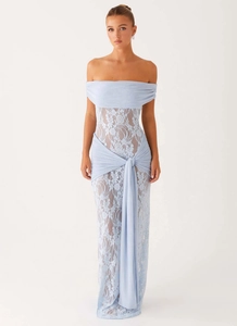 Detail of light blue lace dress featuring off-shoulder neckline and delicate waist ribbons