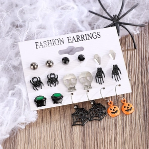 Gothic Halloween earring set featuring black spiders, skulls and pumpkins on spiderweb decor