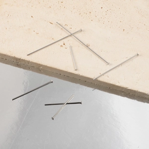 Flat head stainless steel pins for DIY jewelry making on textured stone and silver background