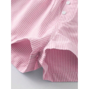 Detailed view of pink striped fabric texture with two white buttons on casual shorts
