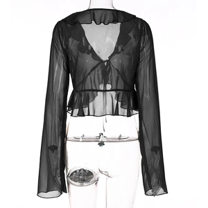Detail view of black mesh top showing ruffle trim v-neck and sexy backless design