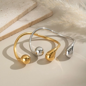 Minimalist stainless steel open bangle with spherical ends in gold and silver finish