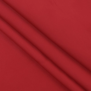 Detailed view of dark red satin fabric showing elegant texture and soft draped folds