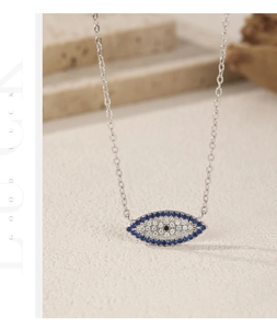 Macro detail of S925 sterling silver evil eye necklace with sparkling blue zirconia