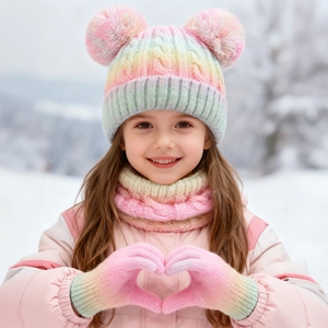 Close-up of kids winter set with rainbow knit hat, pom-poms, scarf, and warm gloves