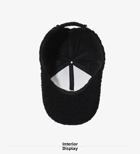 Interior view of black fleece baseball cap showing stitching and soft thermal lining