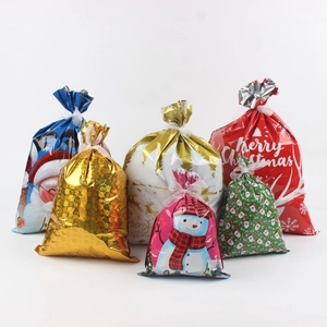 Detailed view of assorted metallic Christmas gift bags with festive patterns and ribbon ties