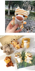 Macro shot of 6 plush jungle animal keychains including lion, elephant, and giraffe