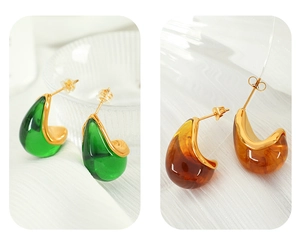 Detailed close-up of emerald green and amber resin teardrop earrings with 18K gold plating
