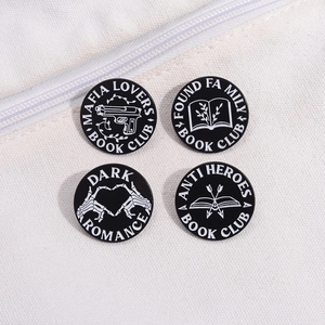 Four black enamel book club pins with white literary quotes on white canvas background