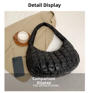 Detail showing the black quilted hobo bag texture with a wide shoulder strap design