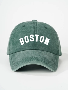 Close-up of the vintage washed dark green cotton twill fabric and white Boston embroidery