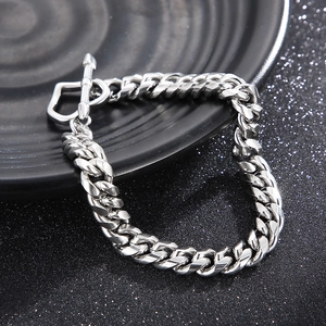 Close-up of 8mm silver Cuban link bracelet with a decorative heart-shaped toggle clasp