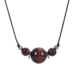 Detailed shot of tiger eye stone beads on a black cord with silver metal spacers
