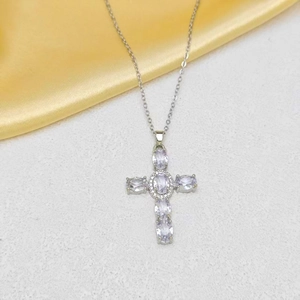 Detailed view of silver cross necklace with lavender oval gemstones and diamond accents