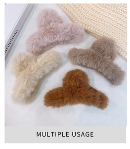 Detailed view of plush faux fur hair claw clips in soft pink, cream, grey and brown tones