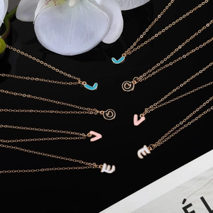 Detailed close-up of rose gold enamel alphabet pendants spelling LOVE on o-chains