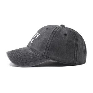 Close-up of the washed grey cotton fabric and white embroidery on the baseball cap side