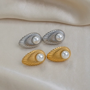 Detailed view of French vintage stainless steel striped stud earrings with pearl inlay.