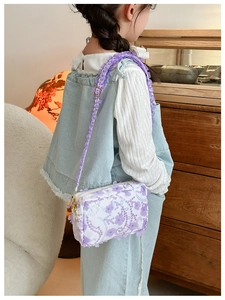 Detail of child floral crossbody bag with purple sequins and ruffled shoulder strap